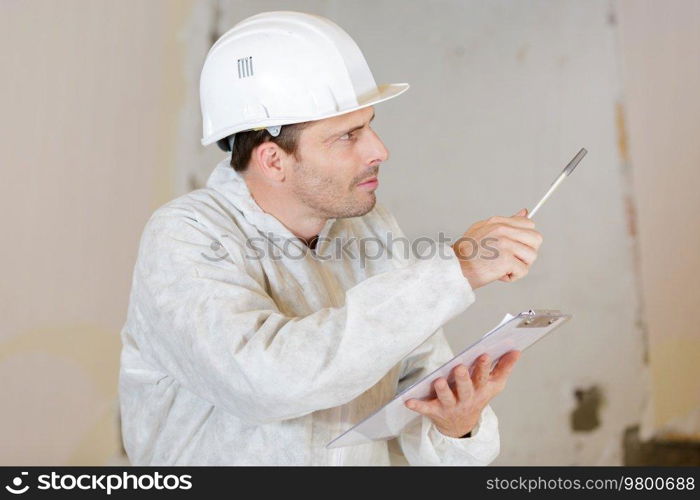 a builder in with clipboard