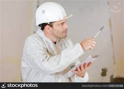a builder in with clipboard
