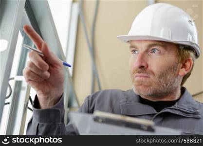 a builder is pointing at something