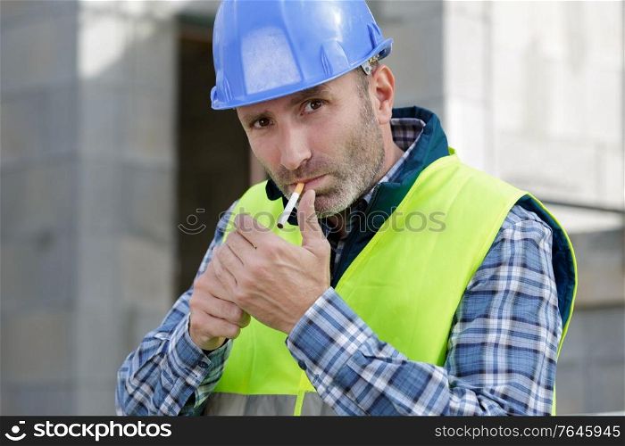 a builder lighting a cigarette