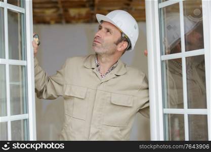 a builder opens window close-up