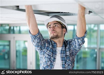 a builder replacing ceiling panel