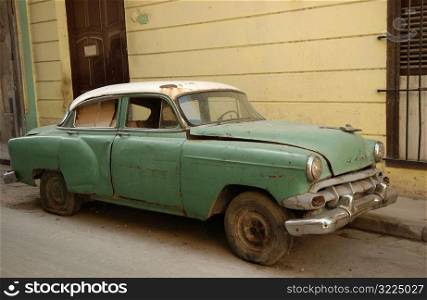 A building structure with an antique car parked in front, Havana, Cuba
