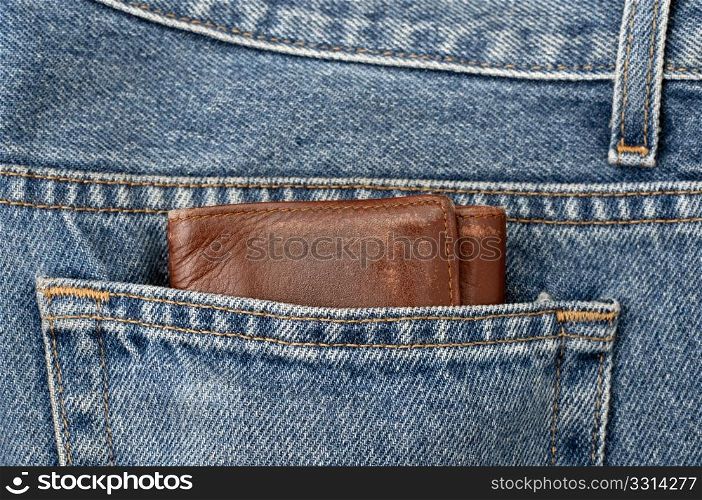A bulky wallet on a jeans pocket, a concept of wealth