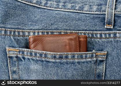 A bulky wallet on a jeans pocket, a concept of wealth