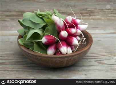 A Bunch Of Fresh Homegrown Radish In A Wooden Bowl On A Wooden Kitchen Table