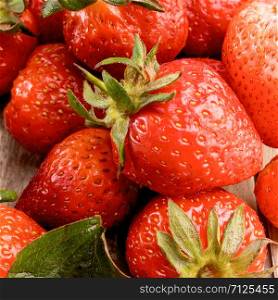 A bunch of fresh red strawberries. Close-up. Freshly picked strawberries closeup. Berries Background.