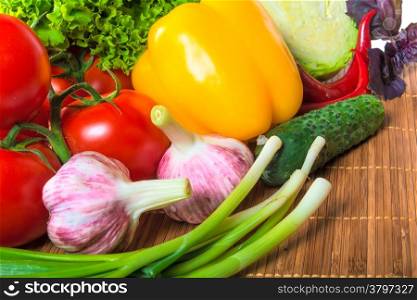 a bunch of healthy vegetables on a wooden napkin