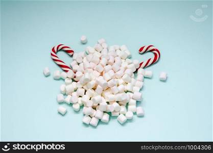 a bunch of Marshmallow and two candy on blue background