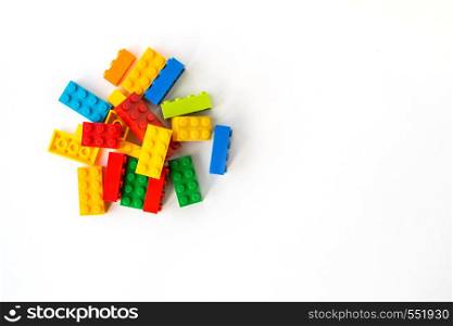 A bunch of Multicolor Plastick constructor bricks on white background. Popular toys. Copyspace. Multicolor Plastick constructor bricks on white background. Popular toys. Copyspace