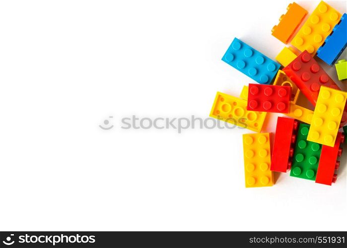 A bunch of Multicolor Plastick constructor bricks on white background. Popular toys. Copyspace. Bunch of many Colorful Plastick constructor bricks on white background. Popular toys. Copyspace