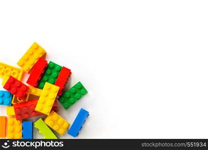 A bunch of Multicolor Plastick constructor bricks on white background. Popular toys. Copyspace. Bunch of Colorful Plastick constructor bricks on white background. Popular toys. Copyspace