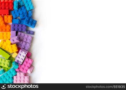 A bunch of Multicolor Plastick constructor bricks on white background. Popular toys. Copyspace. A lot of Colorful Plastick constructor bricks on white background. Popular toys. Copyspace