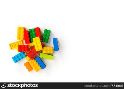 A bunch of Multicolor Plastick constructor bricks on white background. Popular toys. Copyspace. Bunch of Colorful Plastick constructor cubes on white background. Popular toys. Copyspace