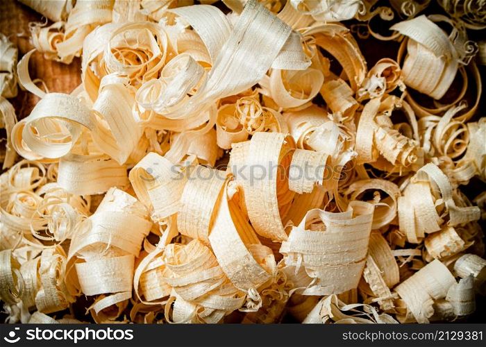 A bunch of wooden shavings. Macro background. High quality photo. A bunch of wooden shavings.