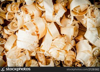 A bunch of wooden shavings. Macro background. High quality photo. A bunch of wooden shavings.