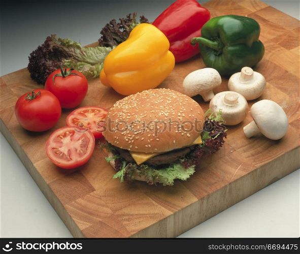a burger and various salad/vegetable items