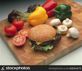 a burger and various salad/vegetable items