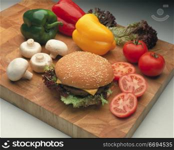 a burger on a bun with salad/vegetable items