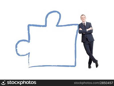 A business man leaning on a piece from a puzzle