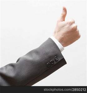 A business man signalling thumbs up