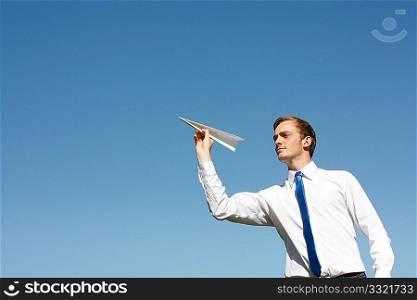 A business man throwing a paper plane