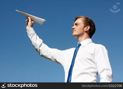 A business man throwing a paper plane