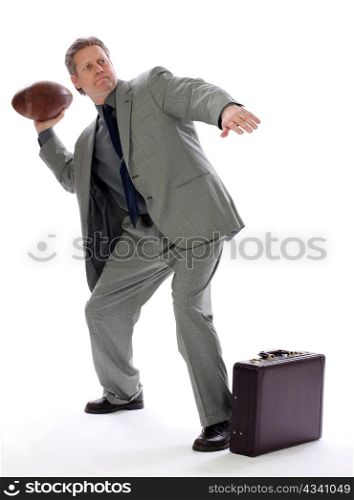 A business man tries to hit his mark with a toss of a football