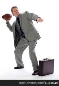 A business man tries to hit his mark with a toss of a football
