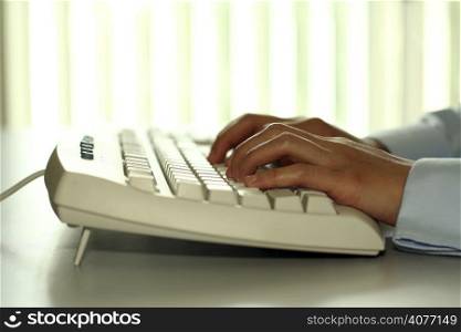 A business person yping on a keyboard