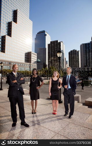 A business team portrait with large buildings in the background