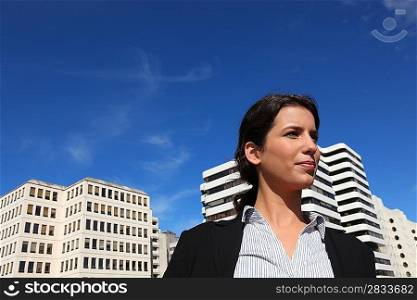 a business woman walking near buildings