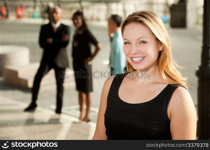 A business woman with colleagues in the background