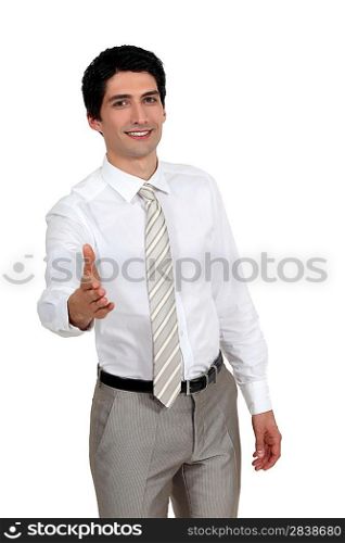 A businessman about to shake hands.