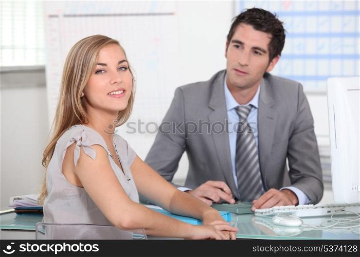 A businessman and a female customer in an office.