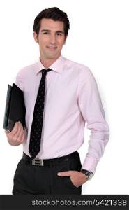 A businessman carrying a folder.