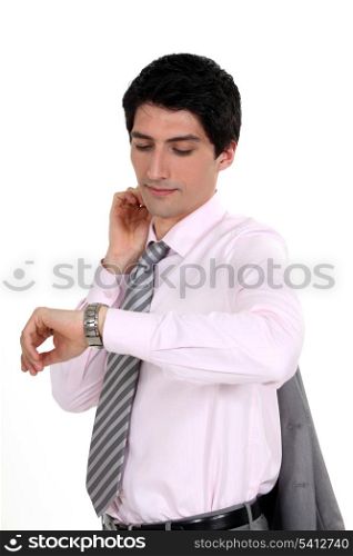 A businessman checking his watch.