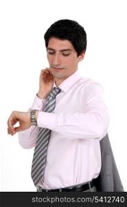 A businessman checking his watch.