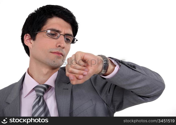 A businessman checking the time,