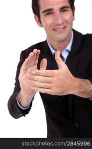 A businessman clapping hands.