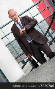 A businessman climbing stairs to his appointment.