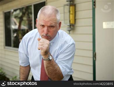 A businessman coughing with a severe chest cold.