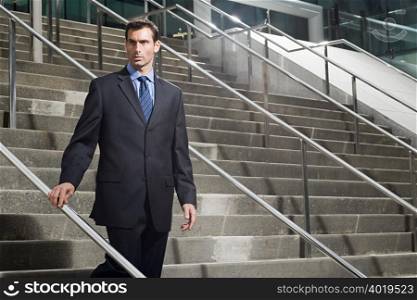 A businessman descending a staircase