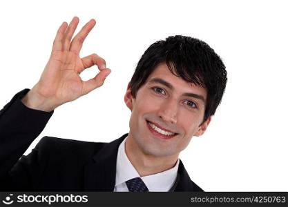 A businessman gesturing an ok sign.