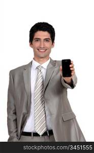 A businessman handing his phone.