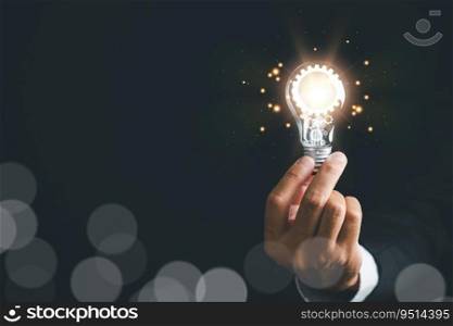 A businessman holding a light bulb, concept of creative thinking and innovation. inspiration and imagination in finding solutions. power of bright ideas and the energy bring to business and technology