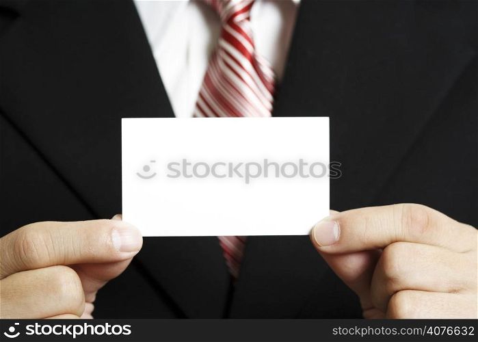 A businessman holding up a blank business card