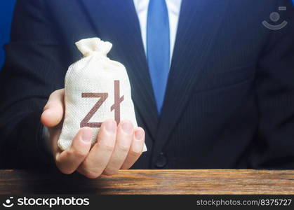 A businessman holds in his hand a polish zloty money bag. Stimulating economic recovery. Investments, financing. Providing business with preferential loans and support during the economic crisis.. A businessman holds in his hand a polish zloty money bag. Stimulating economic recovery. Providing business with preferential loans and support during the economic crisis. Investments, financing.