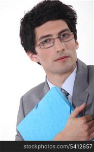A businessman hugging his folder.