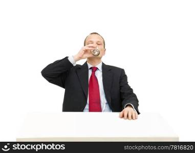 A businessman in a formal suit and necktie drinking a glass of water